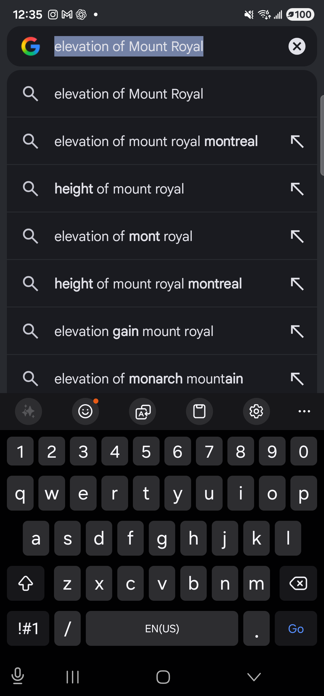 The Google app open full-screen on the Galaxy S23 Ultra in dark mode, on its search-input page. At the top, a dark search bar with the multicolored Google ‘G’ icon on the left contains the pre-filled query ‘elevation of Mount Royal’ with the text selected/highlighted in blue, and a small ✕ clear button on the right. Below the search bar is a vertical list of suggested completions, each with a magnifying-glass icon on the left and an up-and-left arrow on the right: ‘elevation of Mount Royal’, ‘elevation of mount royal montreal’, ‘height of mount royal’, ‘elevation of mont royal’, ‘height of mount royal montreal’, ‘elevation gain mount royal’, ‘elevation of monarch mountain’. Below the suggestions list is the soft keyboard with the standard QWERTY layout, an emoji and clipboard row above it, and the system 3-button nav at the very bottom.