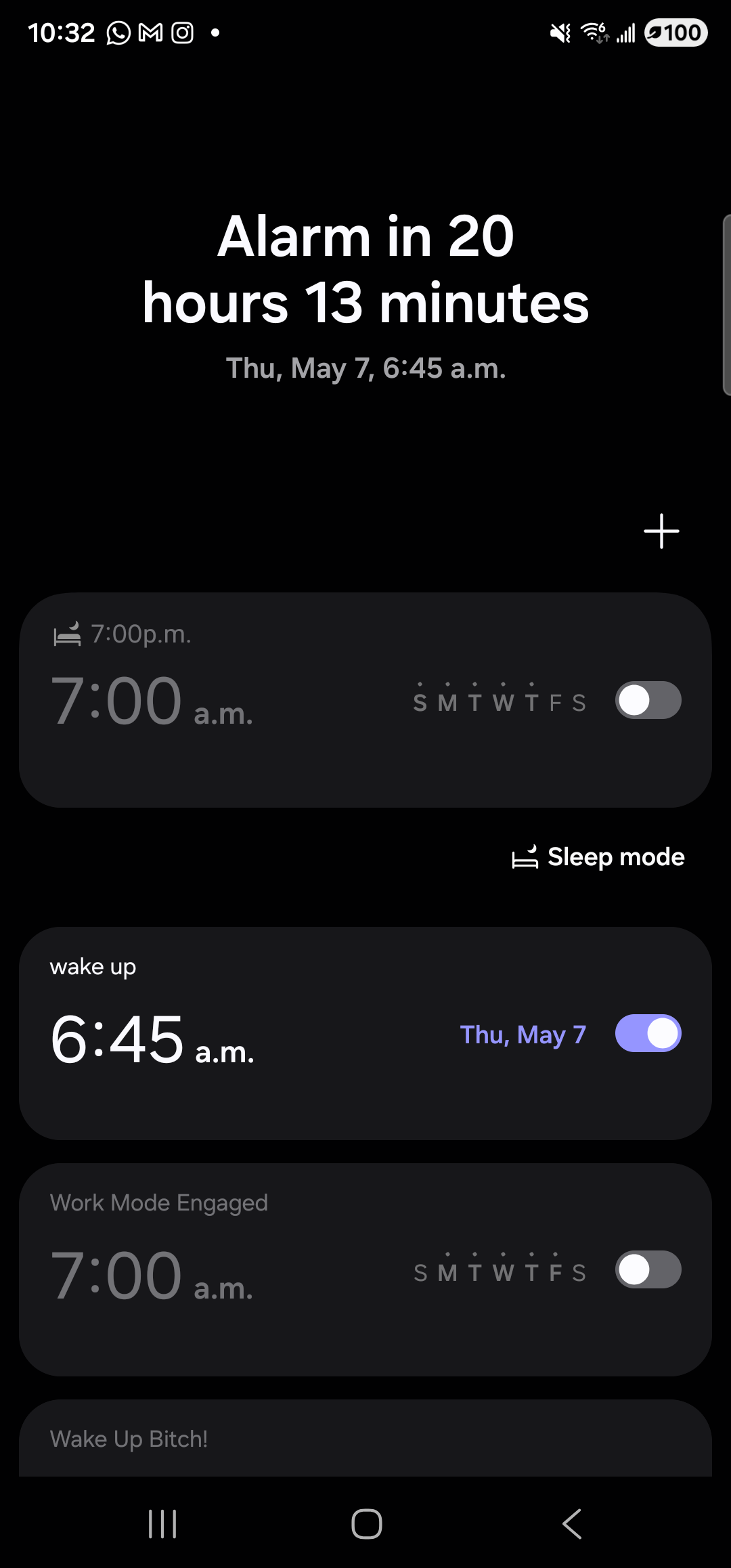 The Samsung Clock app on the Galaxy S23 Ultra in dark mode, on the Alarm tab. At the top of the screen, large white text reads ‘Alarm in 20 hours 13 minutes’ with a smaller line beneath it: ‘Thu, May 7, 6:45 a.m.’. A ‘+’ add-alarm button sits at the right. Below that is a list of alarm rows; the second row is the freshly created one — labeled ‘wake up’ above ‘6:45 a.m.’ on the left, with the day descriptor ‘Thu, May 7’ in violet on the right next to a violet toggle in the on position. Other rows above and below (a 7:00 a.m. ‘Sleep mode’ row, a ‘Work Mode Engaged’ 7:00 a.m. row, a ‘Wake Up Bitch!’ row peeking from the bottom edge) are pre-existing personal alarms, all toggled off.