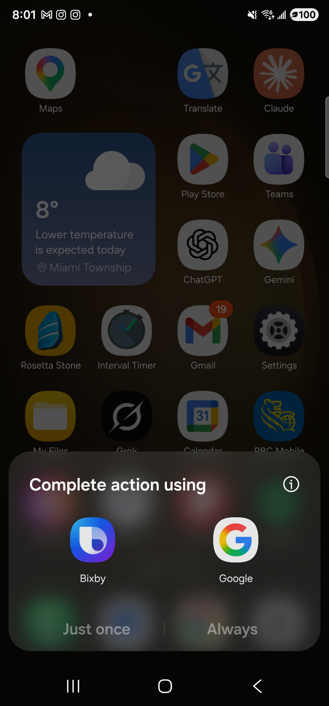 The Android home-screen-launcher app grid, with a system ‘Complete action using’ chooser sheet sitting at the bottom of the screen. The chooser shows two options — ‘Bixby’ and ‘Google’ — alongside ‘Just once’ and ‘Always’ buttons; Aside is not listed because the v0.2.6 build does not yet declare a VoiceInteractionService intent filter, so Android does not consider it a valid assist target even though the ASSISTANT role was written. (Honest capture: the assist gesture and KEYCODE_VOICE_ASSIST currently route to whichever traditional voice app the user picks here, not directly into Aside’s mic. A future Aside build that declares the intent filter will land Aside straight in the listening state from the same gesture.)